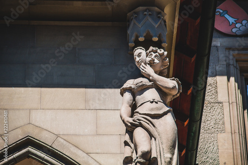 Statue of the right side of the Town hall building (Rathaus) of Bern Switzerland that depicts lie and cowardice
