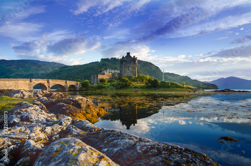 Tourists favourite place in Scotland - Isle of Skye. Very famous castle in Scotland called Eilean Donan castle.  Top of the mountains.Scottish Highlands. Castle with reflection in the lake. photo