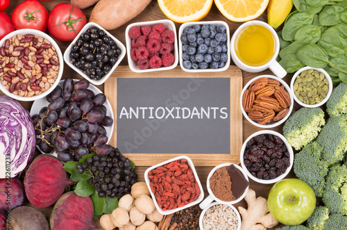 Food sources of natural antioxidants such as fruits, vegetables, nuts and cocoa powder. Antioxidants neutralize free radicals photo