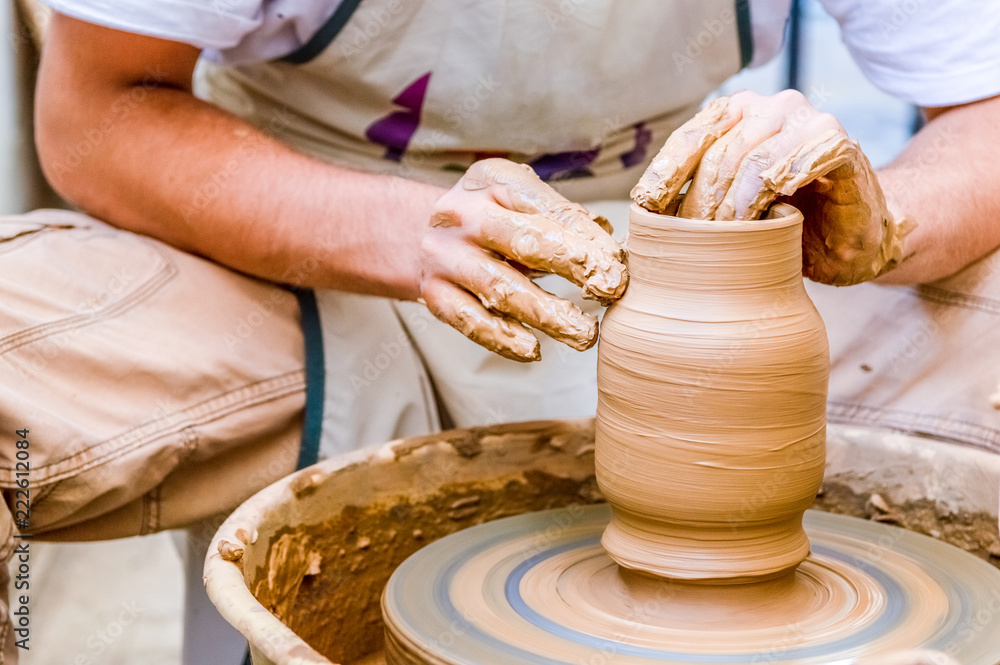 Pottery artist making clay pot in a workshop