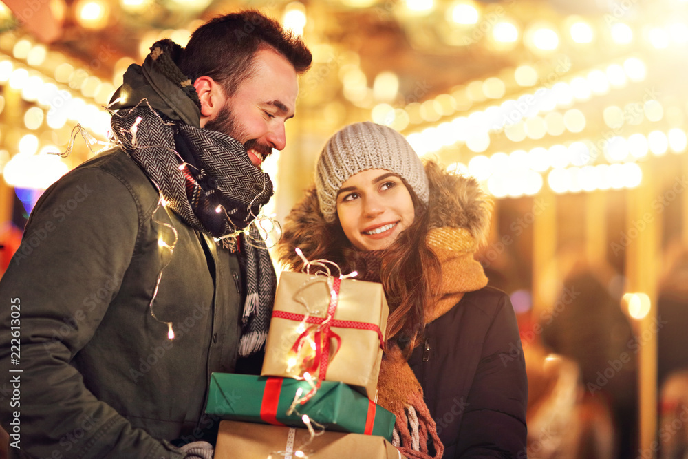© Kalim - Adult couple shopping in the city during Christmas time © Kalim - Adult couple shopping in the city during Christmas time