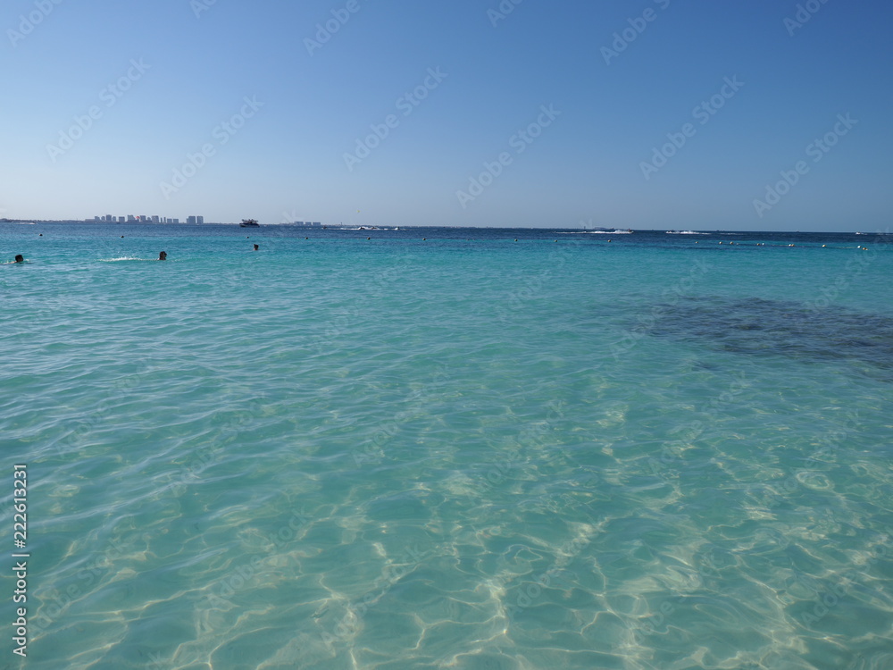 Panoramic view of turquoise waters of Caribbean Sea landscape with horizon line at Cancun city in Mexico Panoramic view of turquoise waters of Caribbean Sea landscape with horizon line at Cancun city in Mexico