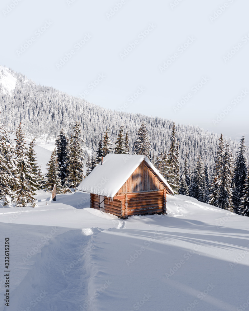 Fantastic winter landscape with wooden house in snowy mountains. Christmas holiday concept. Carpathians mountain, Ukraine, Europe Fantastic winter landscape with wooden house in snowy mountains. Christmas holiday concept. Carpathians mountain, Ukraine, Europe