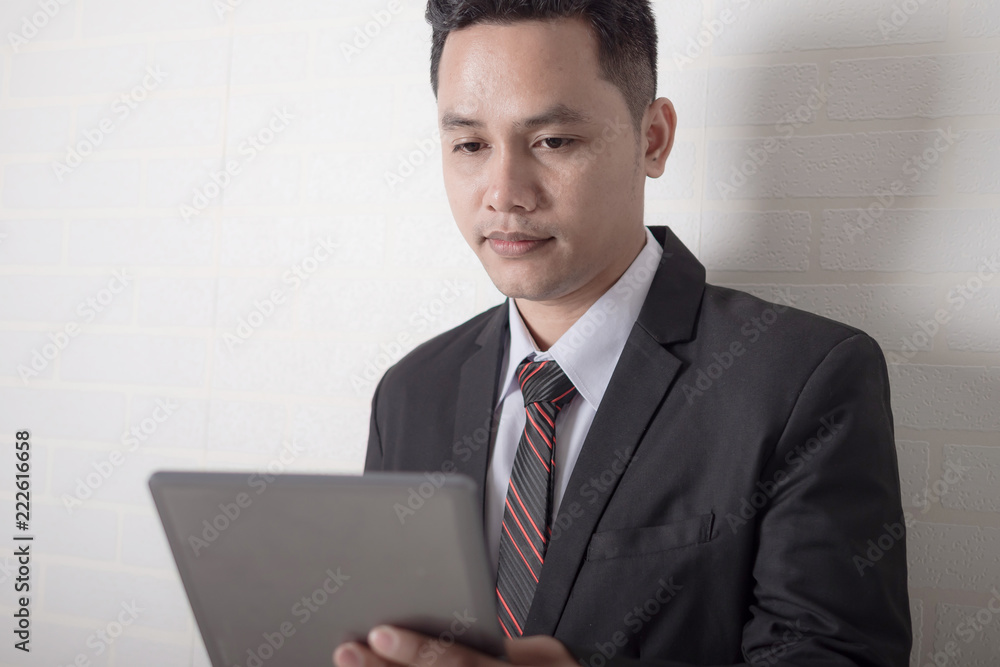 Close up shot Asian businessman using tablet computer Close up shot Asian businessman using tablet computer