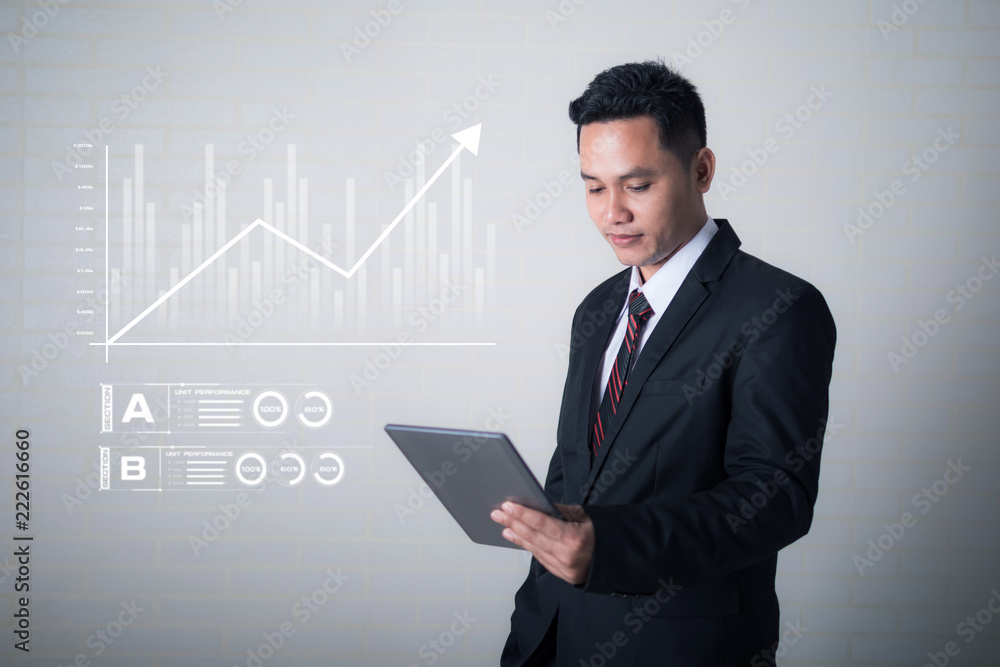 Business man using tablet with hud graph and bar for business futuristic cyber technology concept Business man using tablet with hud graph and bar for business futuristic cyber technology concept