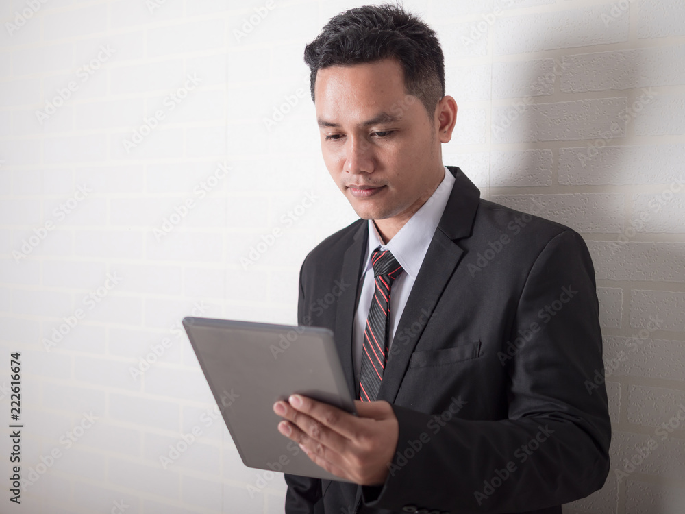 Close up shot Asian businessman using tablet computer for business technology concept Close up shot Asian businessman using tablet computer for business technology concept