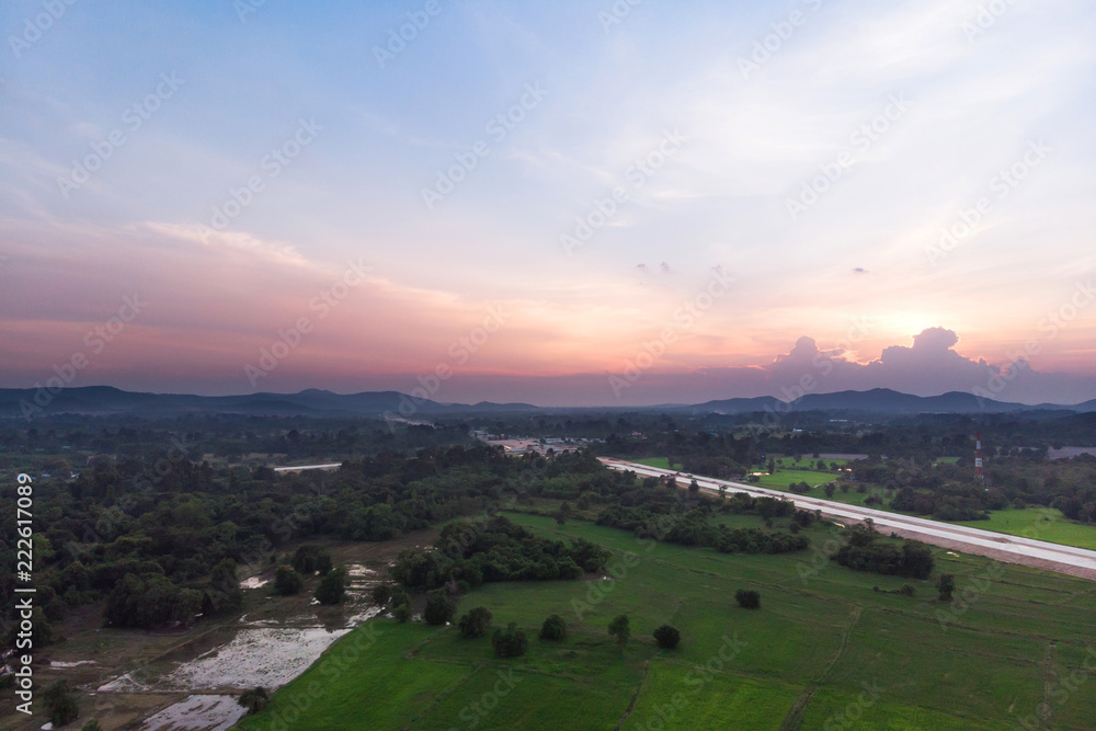 Drone shot Aerial view landscape scenic of rural agriculture rice field with evening sunset atmosphere