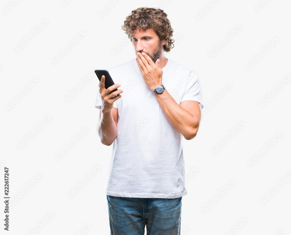 Handsome hispanic man model sending message texting using smartphone over isolated background cover mouth with hand shocked with shame for mistake, expression of fear, scared in silence Handsome hispanic man model sending message texting using smartphone over isolated background cover mouth with hand shocked with shame for mistake, expression of fear, scared in silence