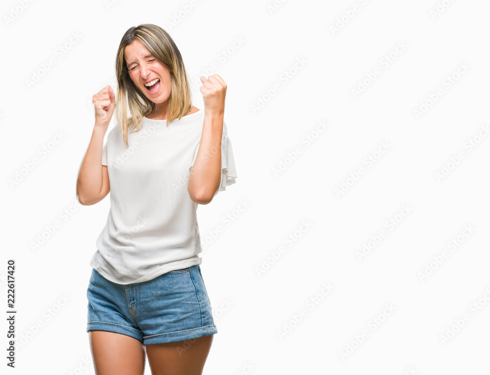 Young beautiful woman over isolated background very happy and excited doing winner gesture with arms raised, smiling and screaming for success. Celebration concept. Young beautiful woman over isolated background very happy and excited doing winner gesture with arms raised, smiling and screaming for success. Celebration concept.