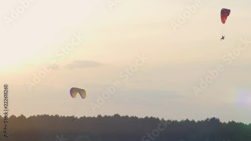 Two paratroopers on the Power ParaChute are flying over the fields