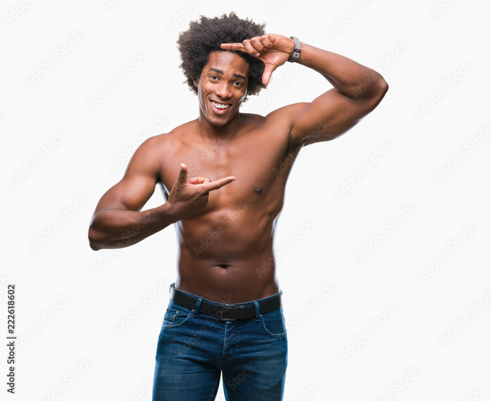 Afro american shirtless man showing nude body over isolated background smiling making frame with hands and fingers with happy face. Creativity and photography concept. Afro american shirtless man showing nude body over isolated background smiling making frame with hands and fingers with happy face. Creativity and photography concept.