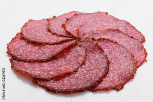 delicious sliced salami on a white background