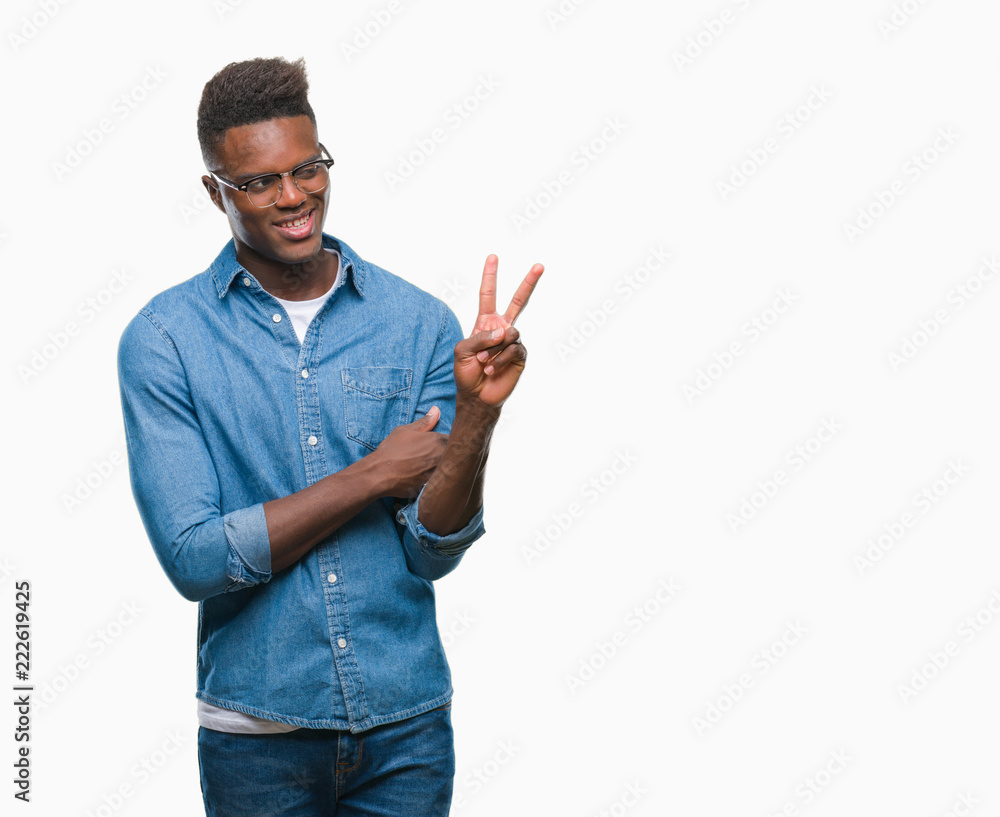 Young african american man over isolated background smiling with happy face winking at the camera doing victory sign. Number two. Young african american man over isolated background smiling with happy face winking at the camera doing victory sign. Number two.