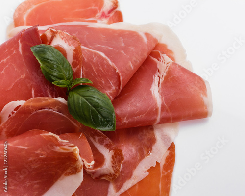 Italian prosciutto crudo or spanish jamon on a white background