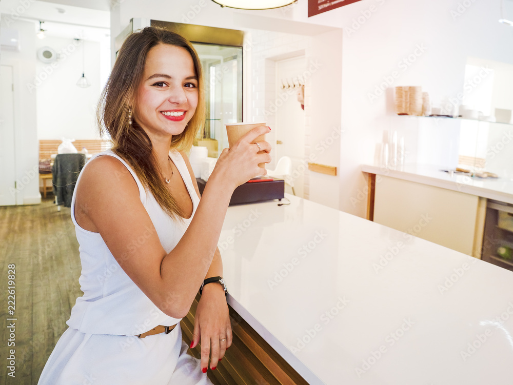 Beautiful girl drinking coffee or tea in a cafe. Beautiful girl drinking coffee or tea in a cafe.