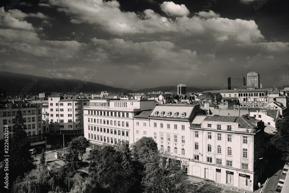 Naklejka premium Aerial view of East European City. Many buildings with a mountain background. Urban sprawl. Rila hotel view. Bulgaria, Sofia - September 1, 2018