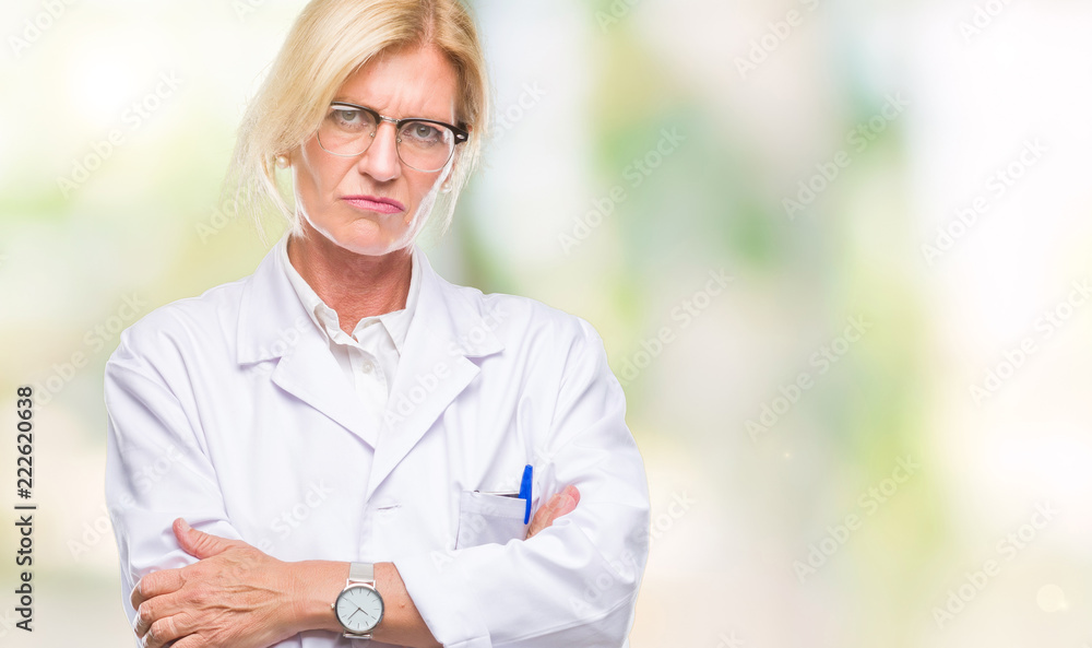Middle age blonde therapist woman wearing white coat over isolated background skeptic and nervous, disapproving expression on face with crossed arms. Negative person. Middle age blonde therapist woman wearing white coat over isolated background skeptic and nervous, disapproving expression on face with crossed arms. Negative person.