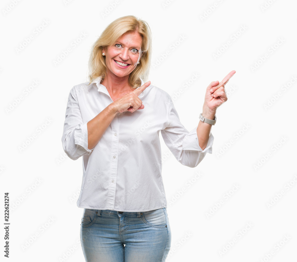 Obraz premium Middle age blonde business woman over isolated background smiling and looking at the camera pointing with two hands and fingers to the side.