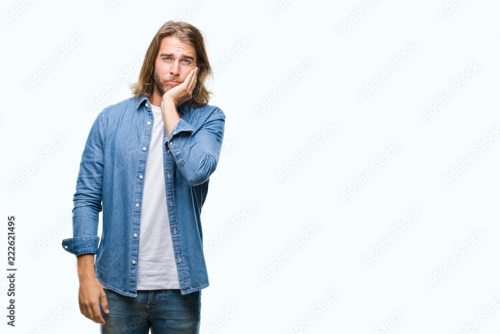 Young handsome man with long hair over isolated background thinking looking tired and bored with depression problems with crossed arms. Young handsome man with long hair over isolated background thinking looking tired and bored with depression problems with crossed arms.