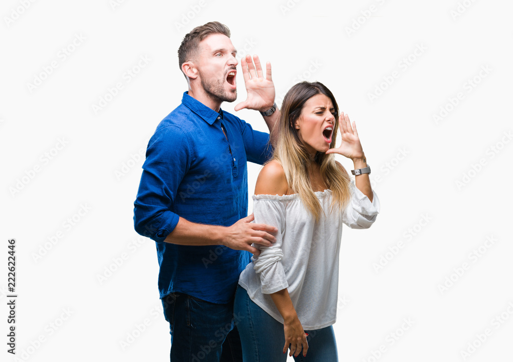 Young couple in love over isolated background shouting and screaming loud to side with hand on mouth. Communication concept. Young couple in love over isolated background shouting and screaming loud to side with hand on mouth. Communication concept.