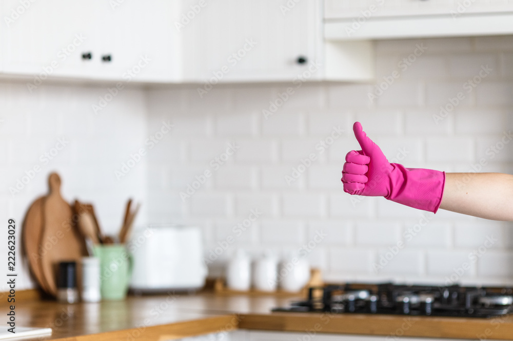 Woman hands wearing protective gloves on white kitchen background. Concept of clean kitchen, successful thumb up yes ok sign - obrazy, fototapety, plakaty 