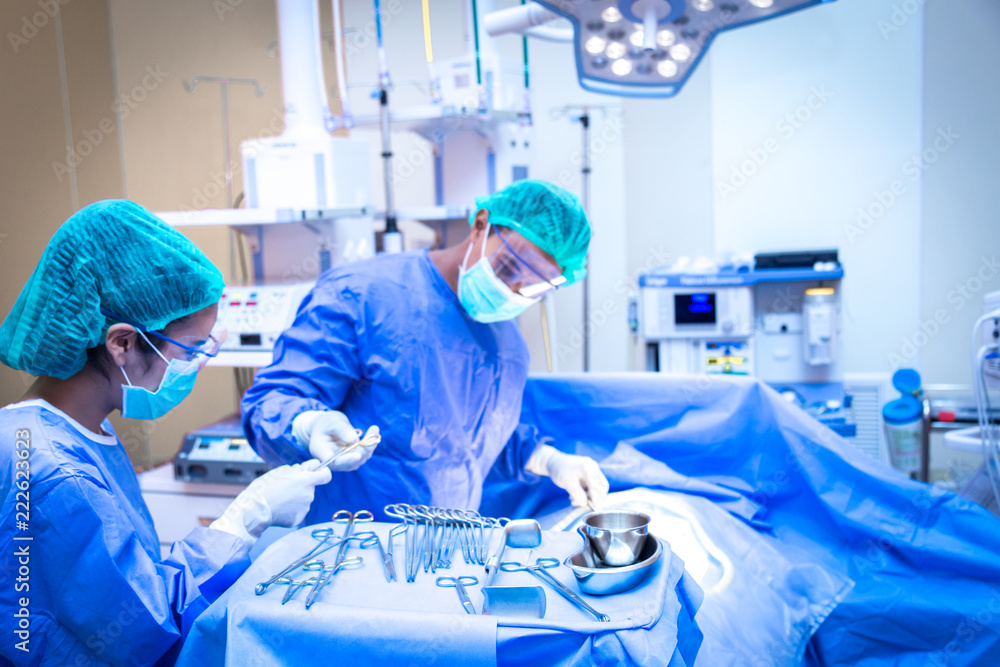Team of surgeon in uniform perform operation on a patient at cardiac surgery clinic.