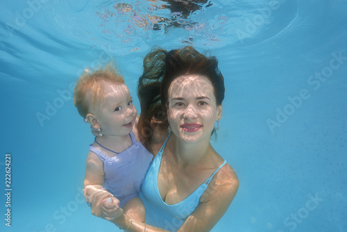 mother and son underwater in the pool