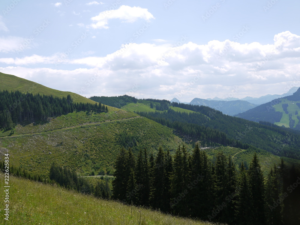 Mountain alndscape with cloudes, forest and fields
