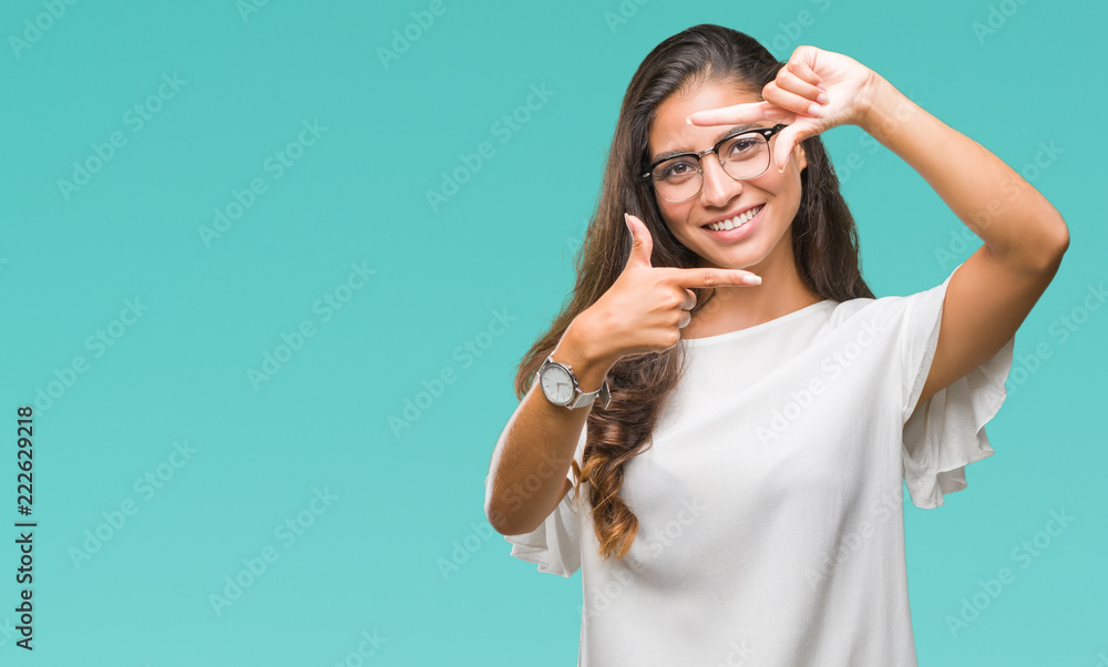 Young beautiful arab woman wearing glasses over isolated background smiling making frame with hands and fingers with happy face. Creativity and photography concept. Young beautiful arab woman wearing glasses over isolated background smiling making frame with hands and fingers with happy face. Creativity and photography concept.