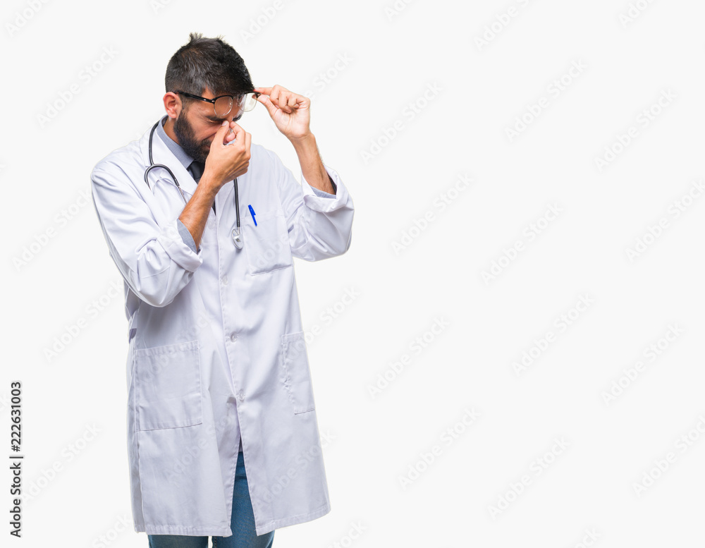 Adult hispanic doctor man over isolated background tired rubbing nose and eyes feeling fatigue and headache. Stress and frustration concept. Adult hispanic doctor man over isolated background tired rubbing nose and eyes feeling fatigue and headache. Stress and frustration concept.