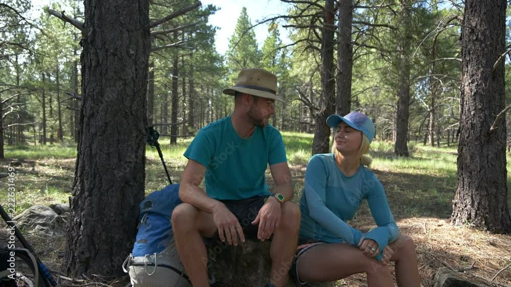 A young couple give a high five after finishing a hike A young couple give a high five after finishing a hike