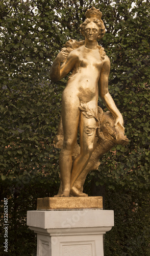 Schwetzingen Palace Garden. Golden statue of Diana the huntress with a boar‘s head. Schwetzingen, Baden Wuerttemberg, Germany, Europe