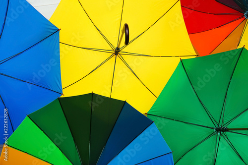 Many stylish colorful umbrellas as background, closeup