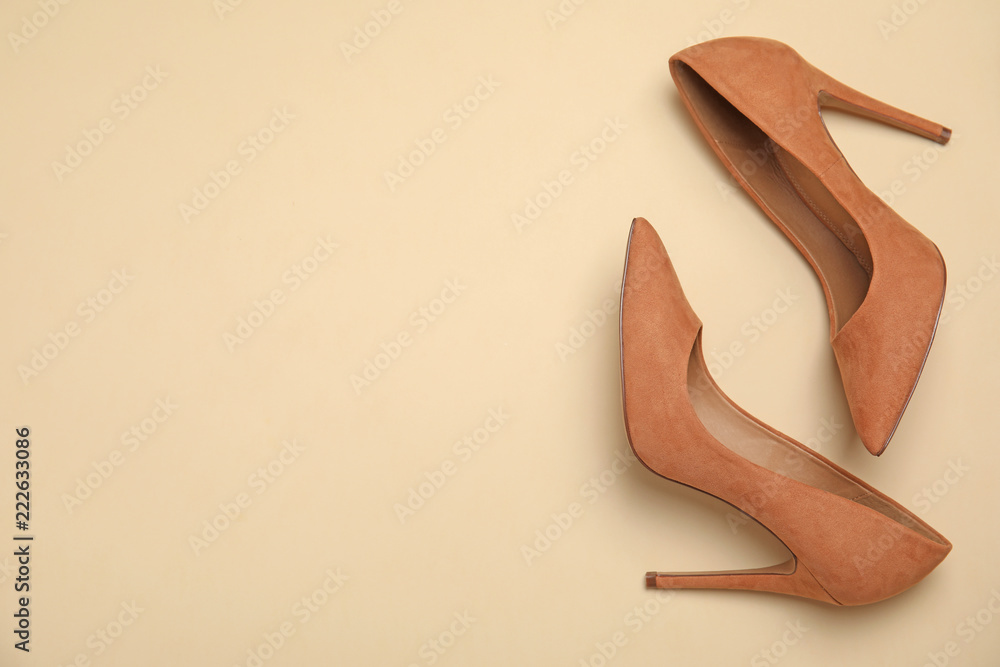 Pair of beautiful shoes and space for text on color background, top view Pair of beautiful shoes and space for text on color background, top view