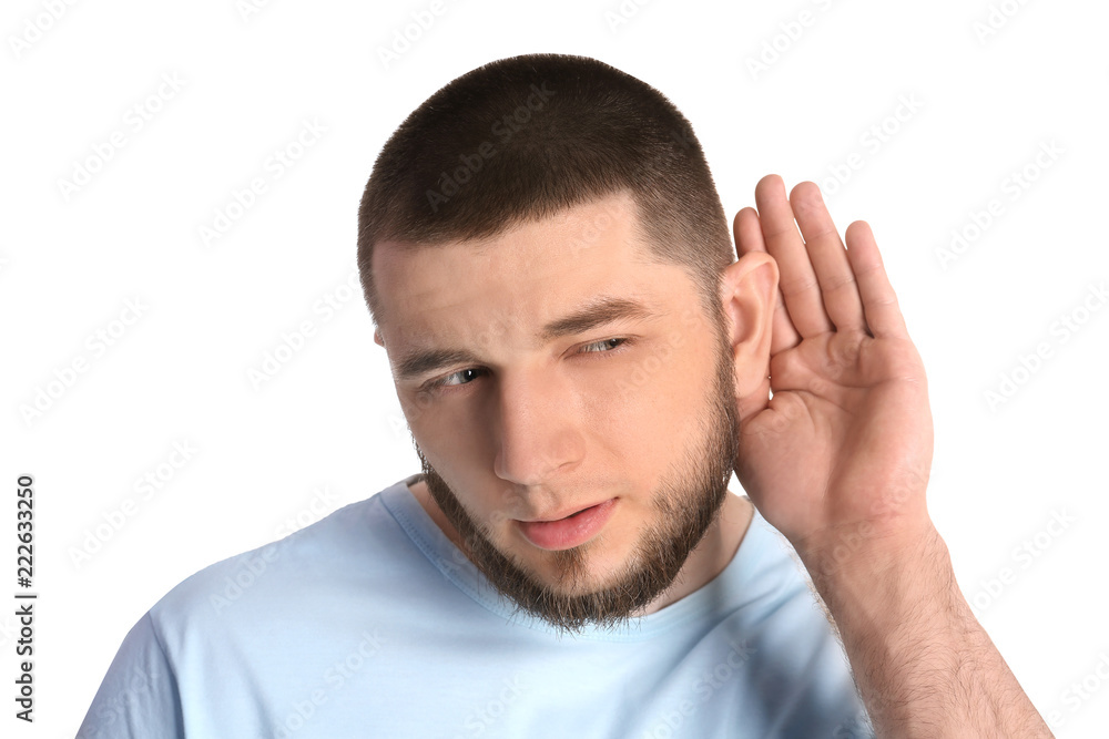 Young man with hearing problem on white background Young man with hearing problem on white background