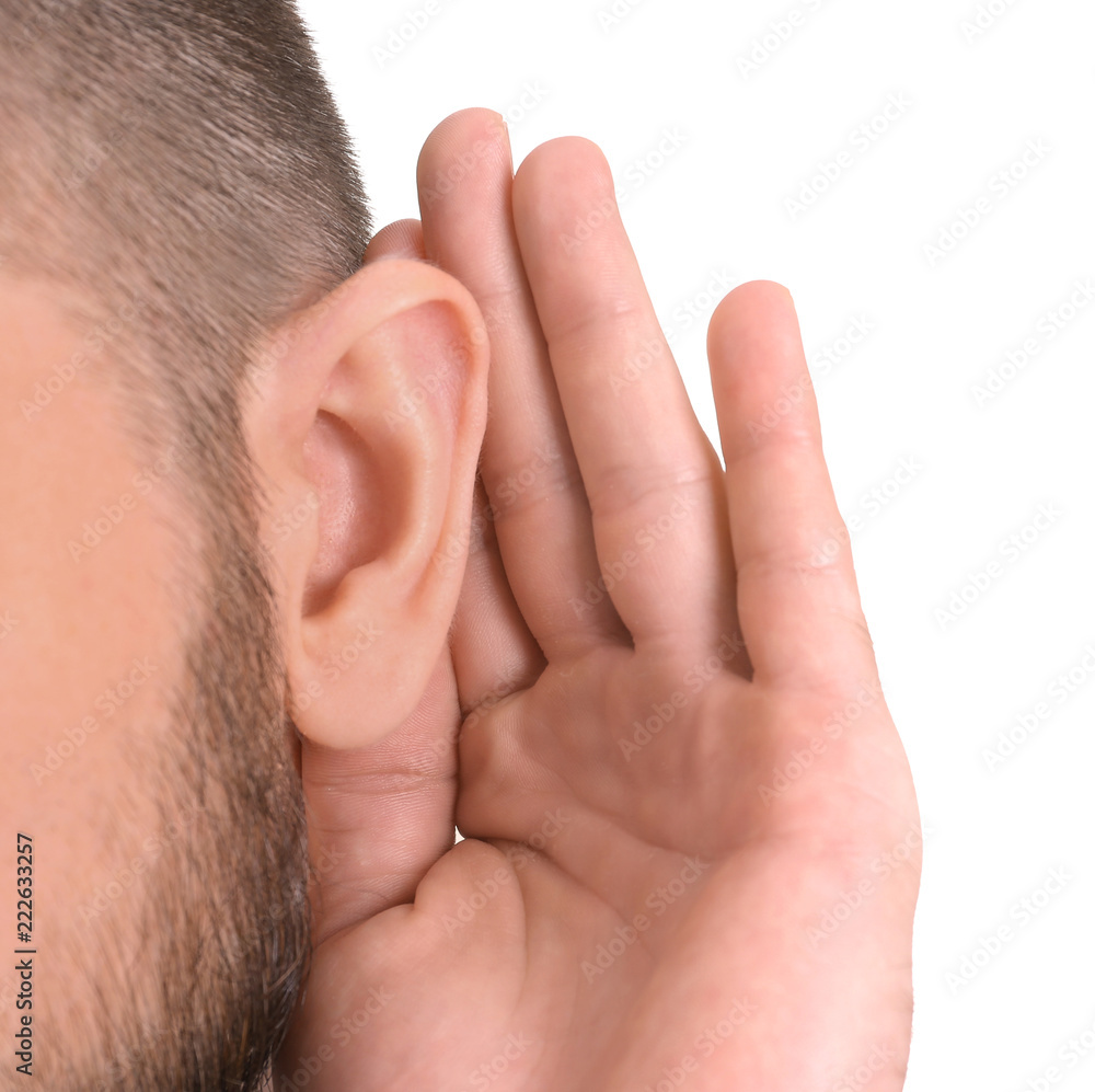 Young man with hearing problem on white background, closeup Young man with hearing problem on white background, closeup