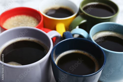 Many cups with tasty aromatic coffee, closeup