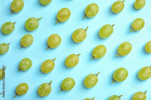 Fresh ripe juicy green grapes on color background, top view