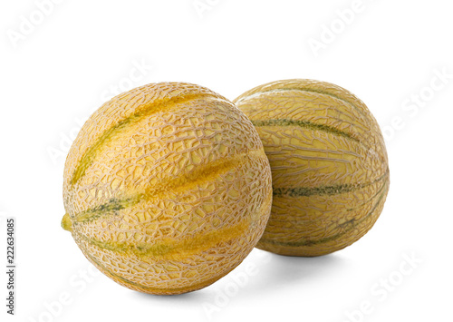 Whole tasty ripe melons on white background