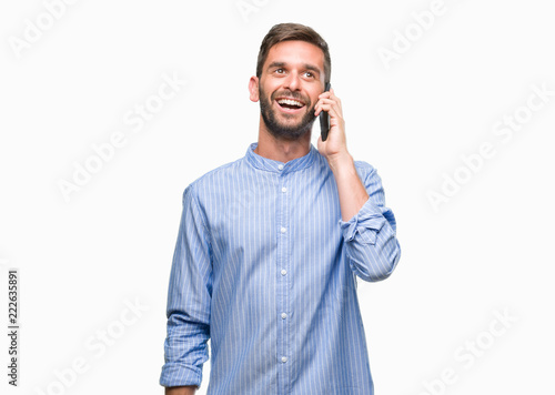 Young handsome man speaking on the phone over isolated background with a happy face standing and smiling with a confident smile showing teeth