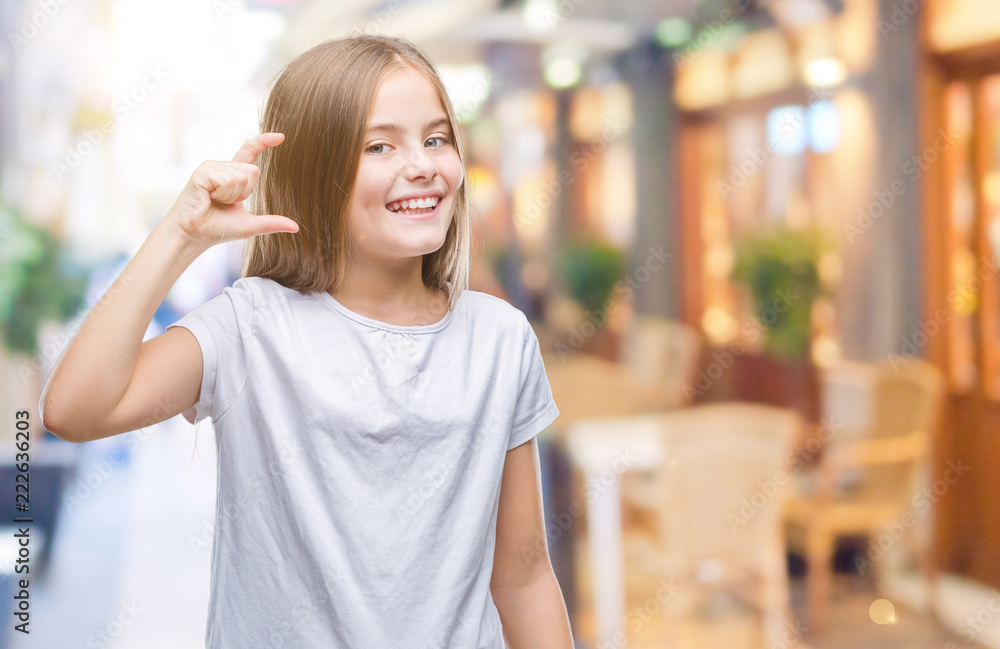 Young beautiful girl over isolated background smiling and confident gesturing with hand doing size sign with fingers while looking and the camera. Measure concept.