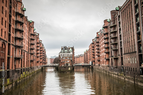 Red buildings over the canals in historic warehouse district in Hamburg, Germany © Ilias Kouroudis