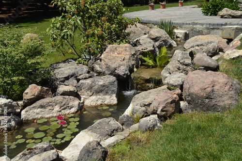 Beautiful pond and Creek with rocks and flowers in the Park this June 3, 2018 Crimea photo