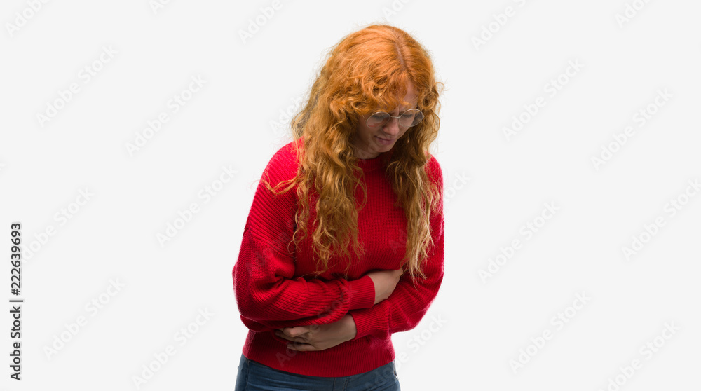 Young redhead woman wearing red sweater with hand on stomach because nausea, painful disease feeling unwell. Ache concept.