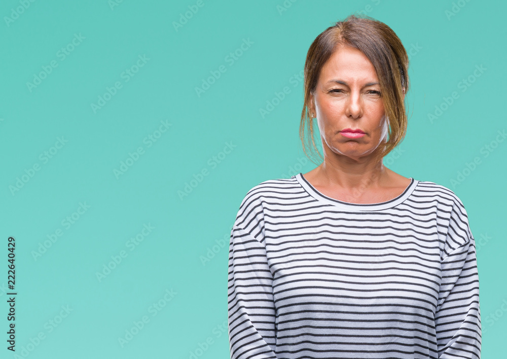 Middle age senior hispanic woman over isolated background skeptic and nervous, frowning upset because of problem. Negative person. Middle age senior hispanic woman over isolated background skeptic and nervous, frowning upset because of problem. Negative person.