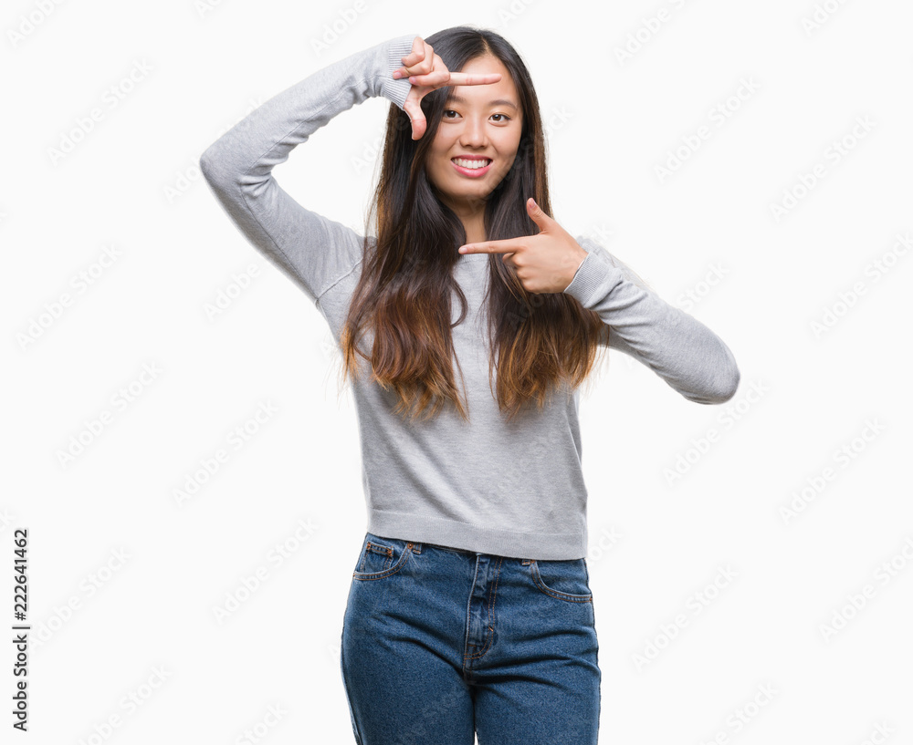 Young asian woman over isolated background smiling making frame with hands and fingers with happy face. Creativity and photography concept. Young asian woman over isolated background smiling making frame with hands and fingers with happy face. Creativity and photography concept.