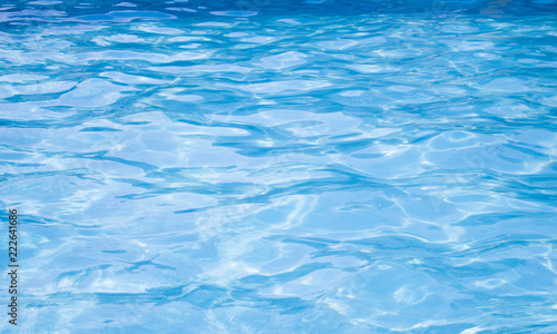Waves in the pool with blue water