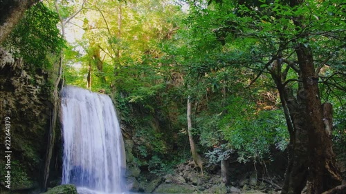 Jungle landscape with flowing blue water of Erawan waterfall with beautiful  