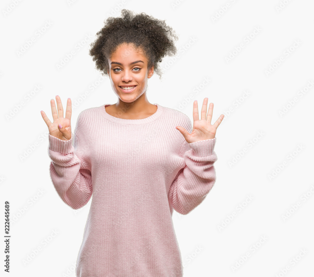 Young afro american woman wearing winter sweater over isolated background showing and pointing up with fingers number nine while smiling confident and happy. Young afro american woman wearing winter sweater over isolated background showing and pointing up with fingers number nine while smiling confident and happy.