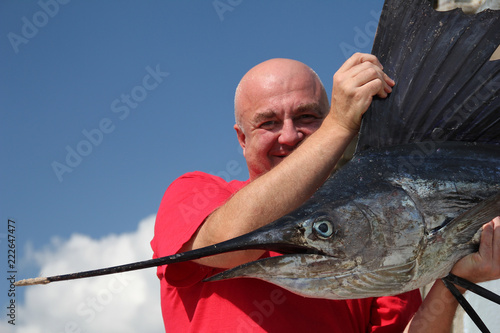 fishing for a sailfish (Istiophorus platypterus). Fisherman with sailfish (fish-sword). fishing in Cuba photo